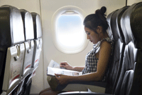 passenger reading on airplane