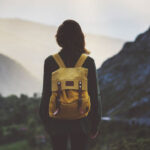 hiker looking at mountain sunset