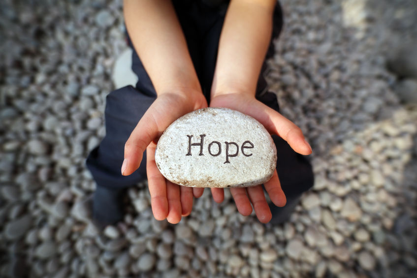 hands holding hope rock