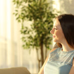 woman looking out window thinking